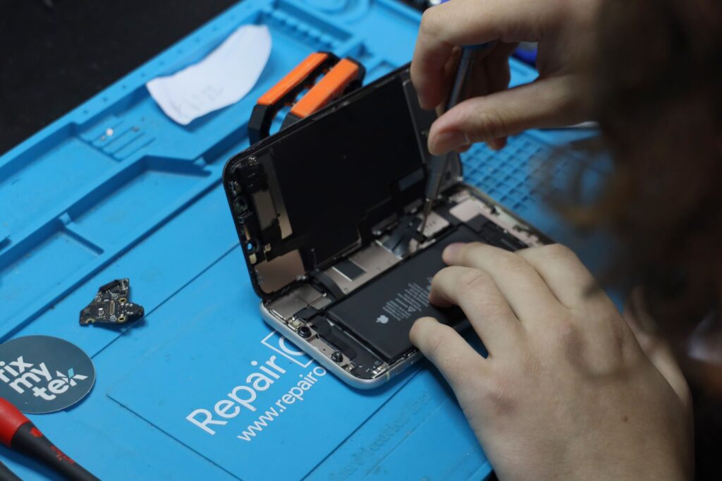 Repair technician working on an iphone battery