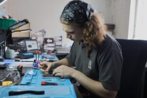 Repair technician works on iphone